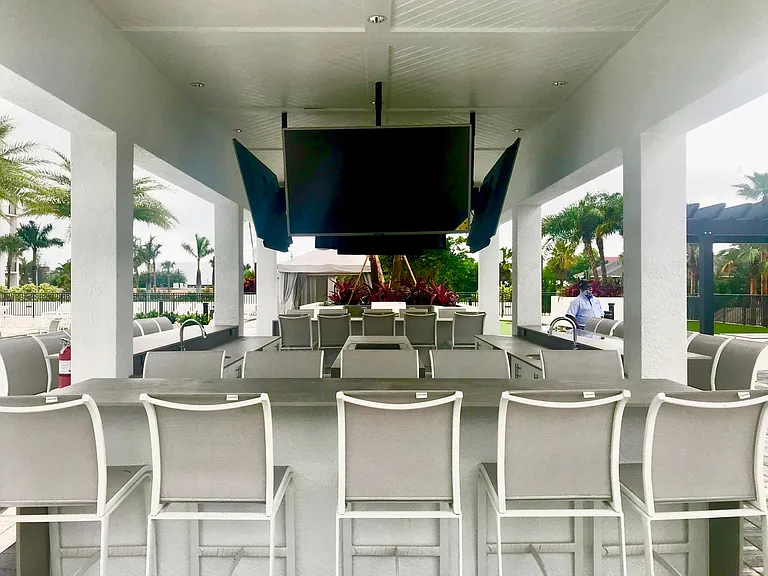 Cabana bar with large screen TV's, refrigerators and ice makers. Bring your cocktails and watch the game!
