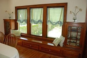 Original built-in window seat and display in large dining room.