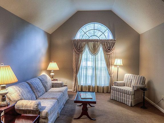 Formal living room features large Palladium window.