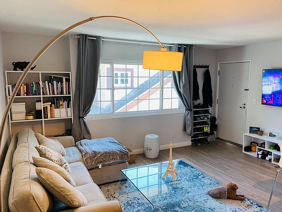 Living room with refreshing natural lighting, book nook, flat panel television mount capability