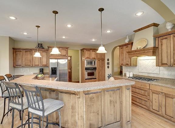 Gourmet kitchen with cambria counter tops, ss/appliances, custom cabinets, and beautiful hardwood floors.
