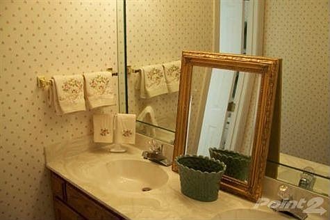 Hall bath up with beveled mirror.