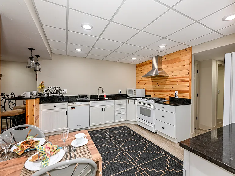 Full kitchen includes dishwasher, microwave, gas cooktop with electric oven and drop-down Murphy table.