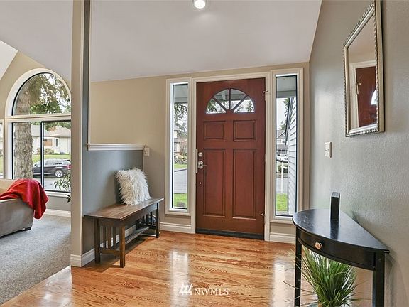 Cathedral ceiling, hard wood floors in endtryway and kitchen, new carpet. new paint, custom trim throughout.