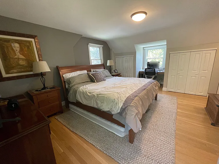 Primary bedroom with built-in closets and work space in dormer.