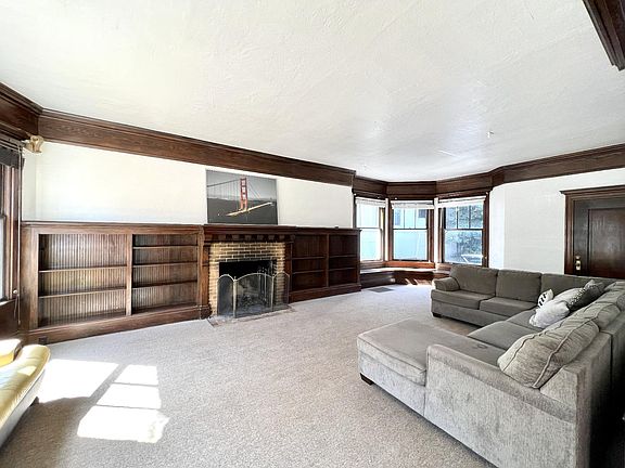 Large living room area with working fire place