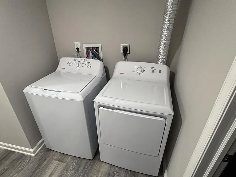 Dedicated laundry nook with a full-size washer and dryer for convenient in-home laundry and easy maintenance.