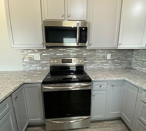 Top of the line Frigidaire stove/oven and microwave. Beautiful tile backsplash and grainite countertops.