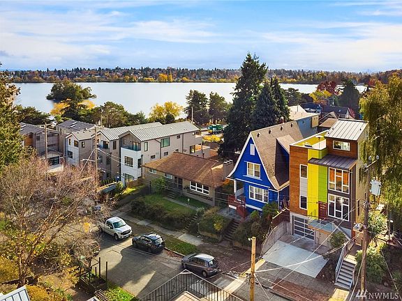 Modern Greenlake smart home with rooftop deck, Lake and Mt. Rainier views, cedar siding, metal roof, and modern and vibrant colors. Steps to Green Lake in a prime location!