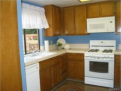 KITCHEN WINDOW LOOKING OUT TO FRONT PATIO ENTRANCE