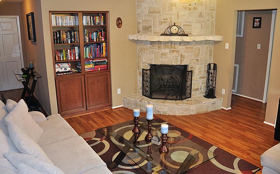 Welcome to your new home, as you walk in you see a beautiful brick fireplace, wood flooring and very