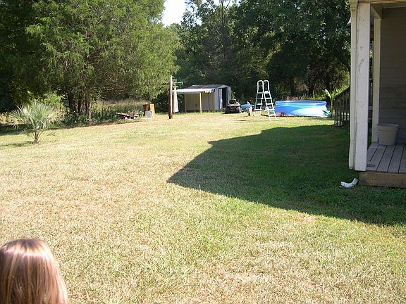 Left side yard with shed and kiddie pool