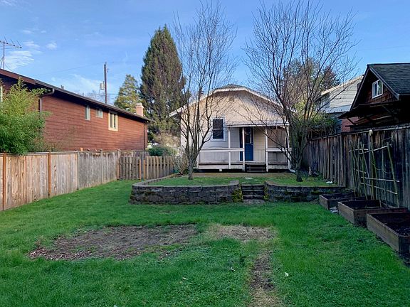 Large, fenced backyard with deck and patio.