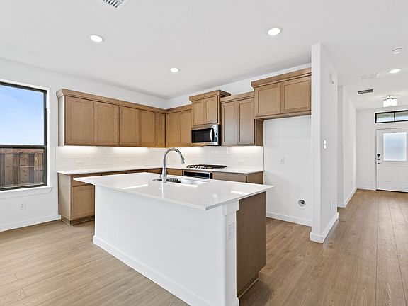 Kitchen in the Stanley II home plan by Trophy Signature Homes - REPRESENTATIVE PHOTO