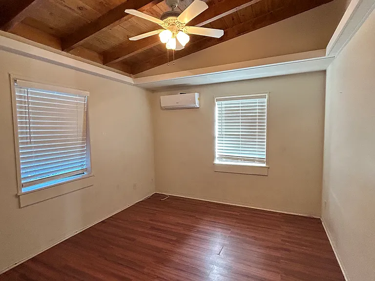 Bedroom with vaulted cypress ceiling and individually controlled air conditioning.
