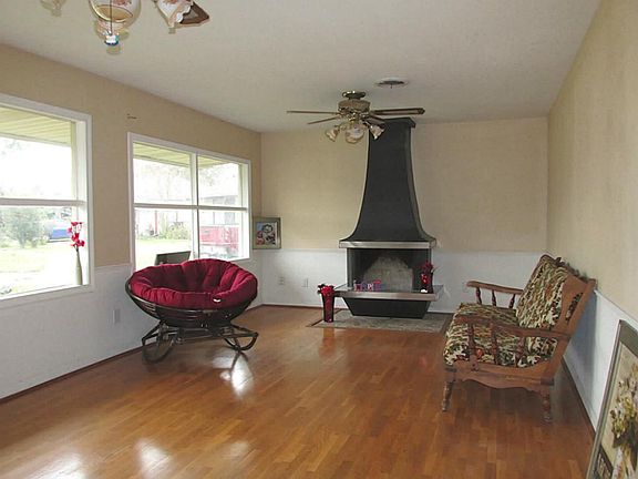LIVING ROOM WITH FIRE PLACE, WOOD FLOORS AND LOTS OF NATURAL LIGHTING