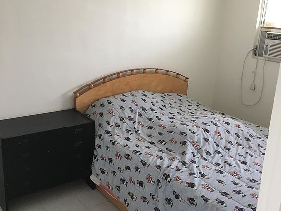 Larger bedroom with A/C, full closet, and additional storage.