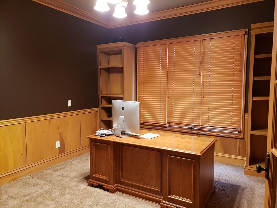 Home office with built in bookcases, desk and computer