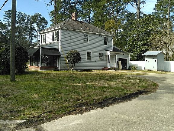 Concrete driveway and small Shed