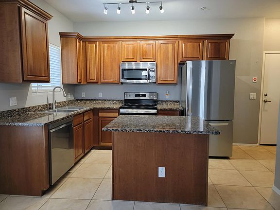 Kitchen with new stainless steel appliances and center island.