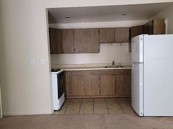 Kitchen comes with new refrigerator, stove with oven, and microwave. It's cute but not remodeled.