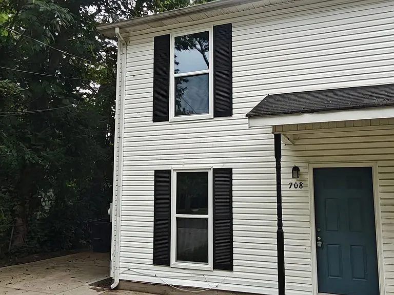 This unit is the left side of a duplex. It has a new concrete driveway.