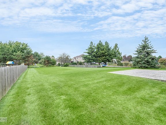 This yard is not fenced, but there are fences on two sides!