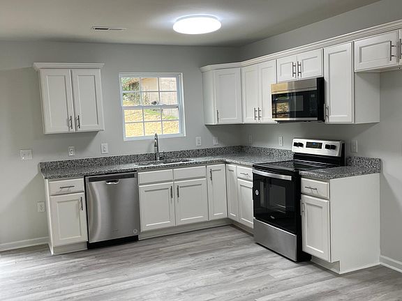 open floor with granite top counters there will be a side by side stainless steel refrigerator lots of cabinets and counters space
