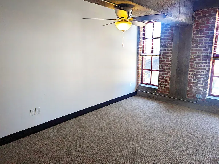 Large windows and ceiling fan in a unit at 3 Points Loft.