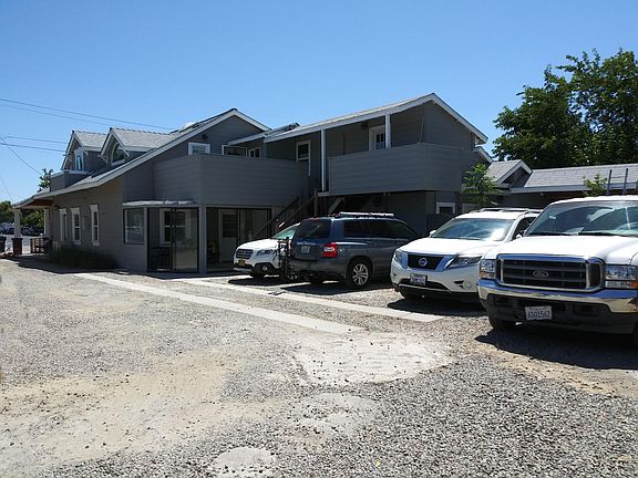 Another view of parking area. Windows and door to unit #3 just visible over deck wall.
