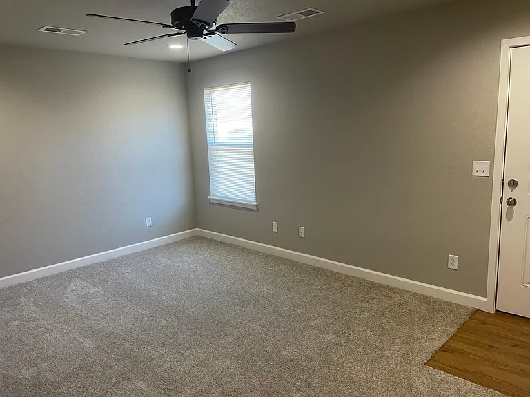 Master bedroom with door to back of unit