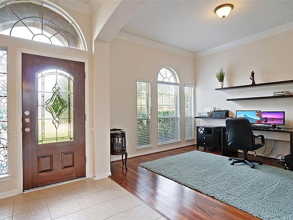 The tall ceilings and elegant floors open this entryway.