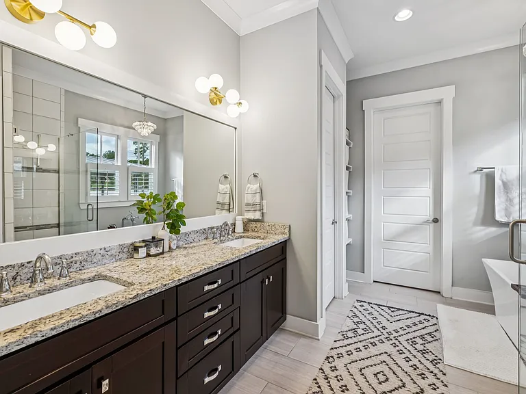 Ensuite bath to primary bedroom. Luxurious spa bath with a tiled shower, soaking tub, double vanities, walk-in closet, and its own laundry area.
