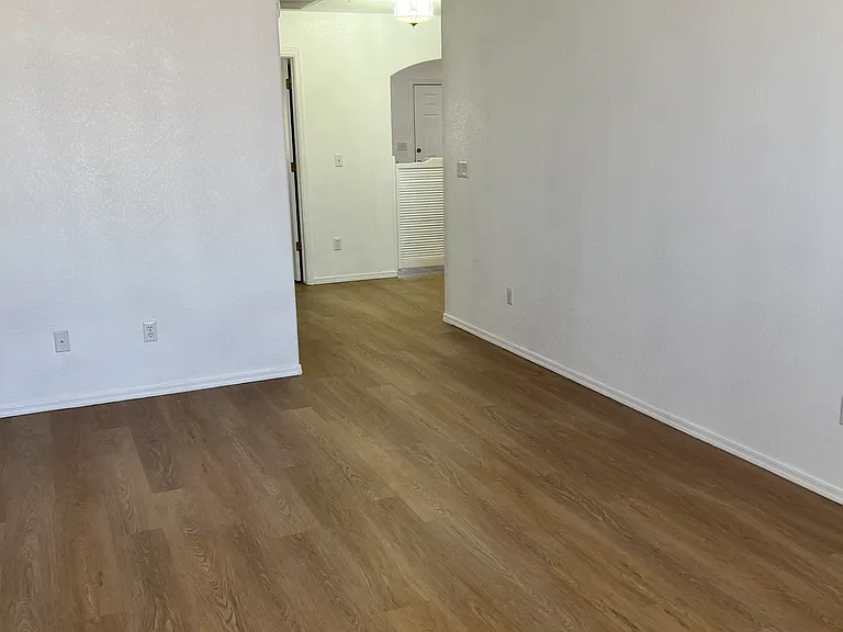 Living room of one bedroom facing kitchen