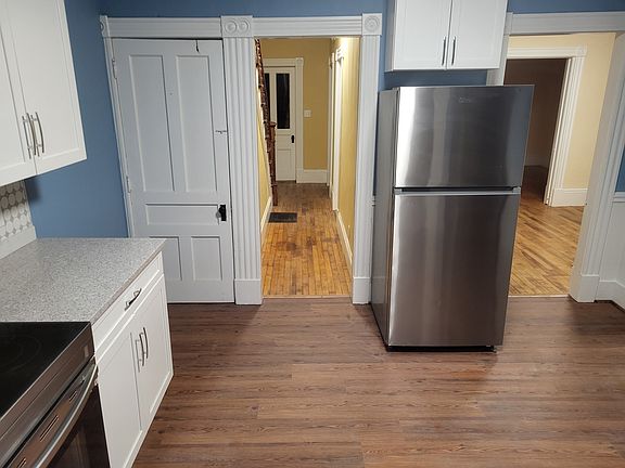 Kitchen with new refrigerator, looking toward front hallway and dining and living rooms