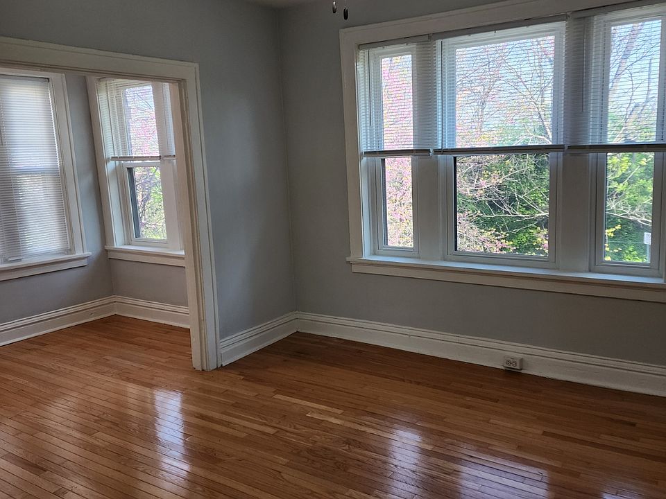 View of the front room walking into the unit. Beautiful Hardwood floors throughout. Updated Modern Ceiling fans.