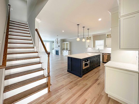 Foyer entry with hardwood stairs