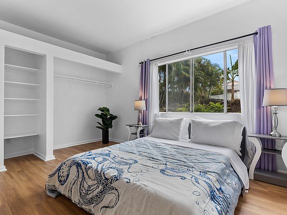 Cozy queen bedroom with vibrant island decor and plenty of natural light