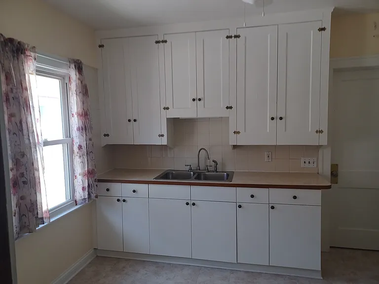 Kitchen view 1 with original top cabinets and new lower cabinets.
