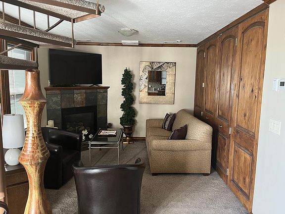 Living room and bedroom separated by wood partition design to