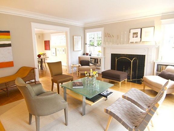 Gorgeous hardwood floors flow through French doors into a lovely living room with coved ceilings, ti