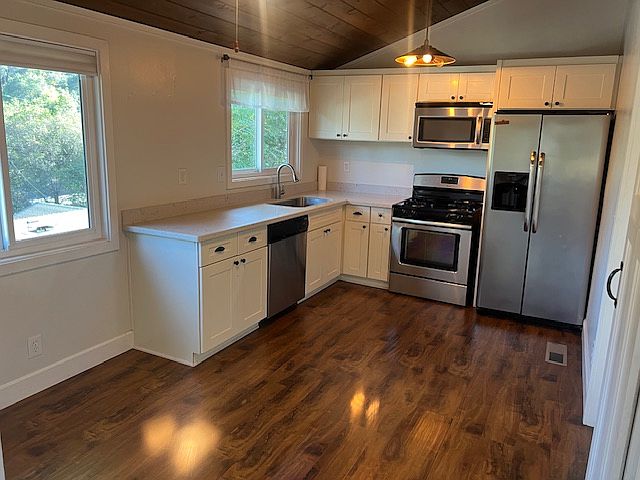 Modern kitchen with stainless appliances and gas range