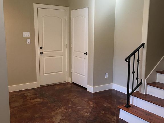 Down stairs living area also door to garage and Utility