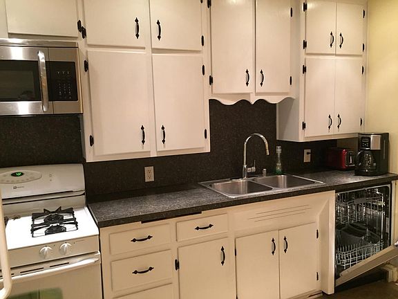 Plenty of cupboard space full of all the dishes and applianc