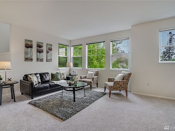Main level Living room with New fresh carpet throughout! Looks at all the natural light that floods into this room. 