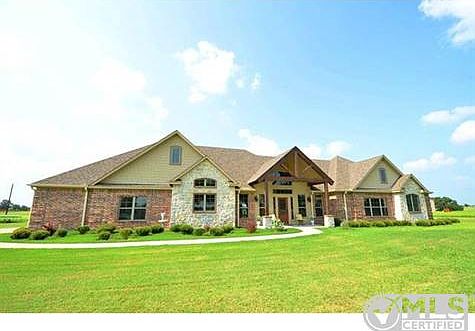 Custom built Taylor Barnes home with stone, brick and Cedar