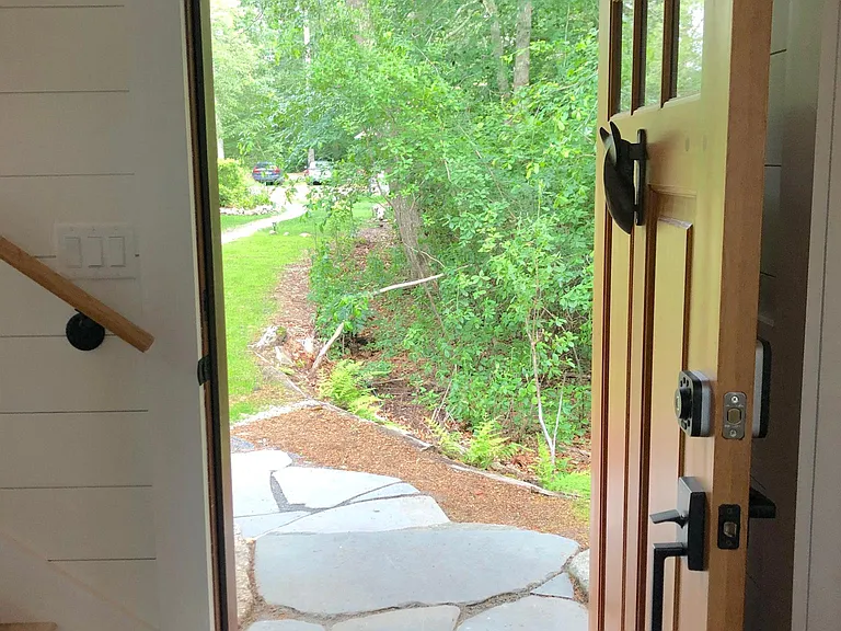 cottage is accessed by a woodland path