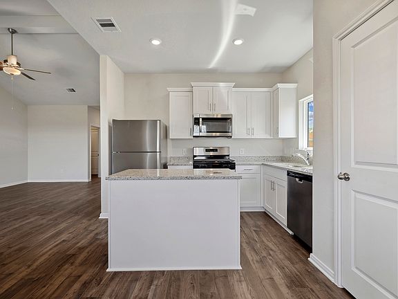 A chef-ready kitchen with granite countertops.