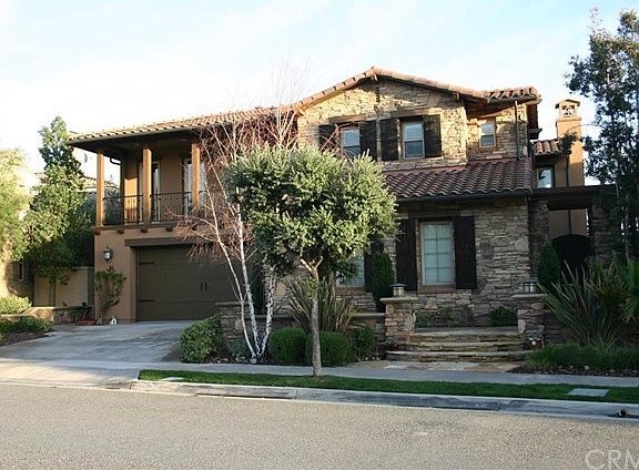 Stone and stucco exterior, with custom made wood shutters, and custom made front entry gate. Wired f