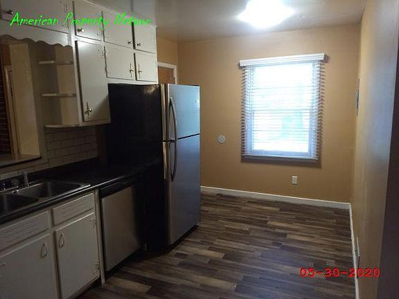 Kitchen with small eating area. Exterior door to backyard.